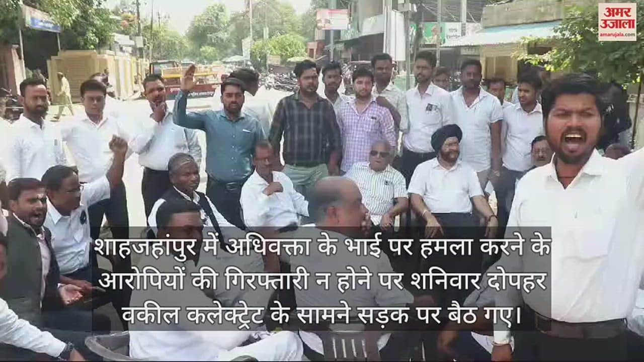 VIDEO : शाहजहांपुर में कलेक्ट्रेट के सामने बीच सड़क पर कुर्सी डालकर बैठे वकील, पुलिस के खिलाफ नारेबाजी
