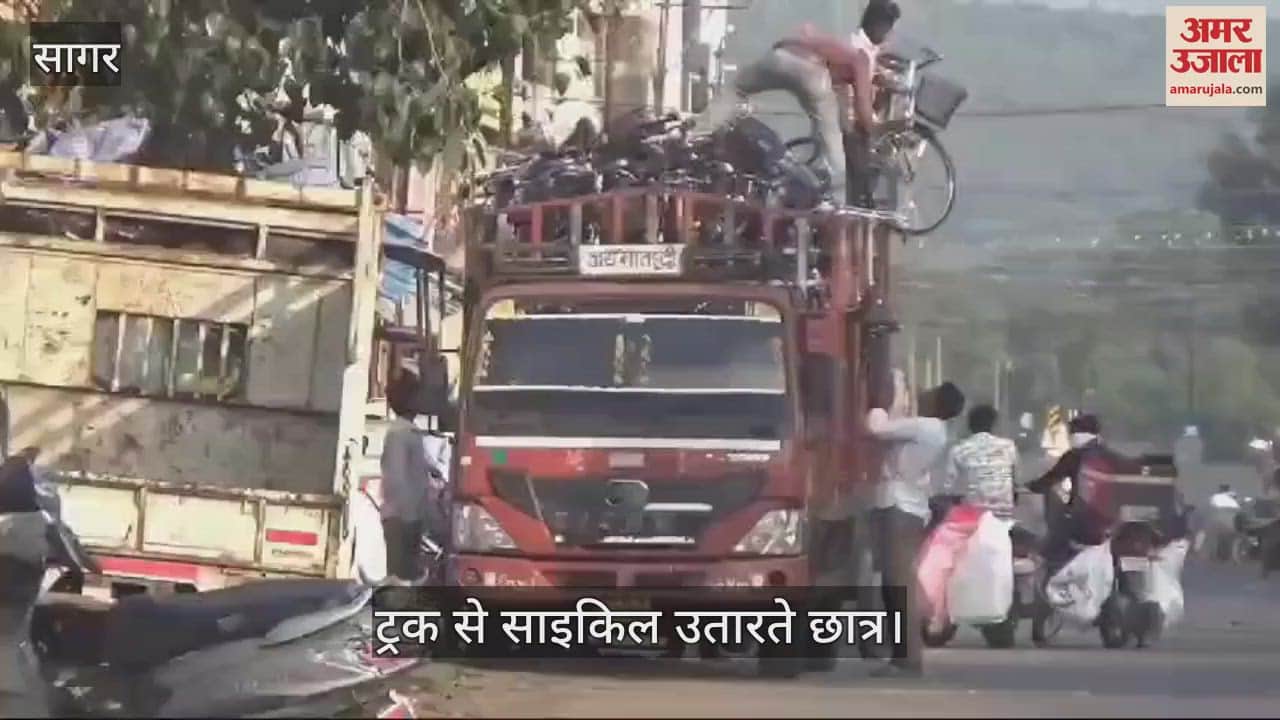 Risky work: School students were seen unloading the bicycles that came to be distributed in the school.