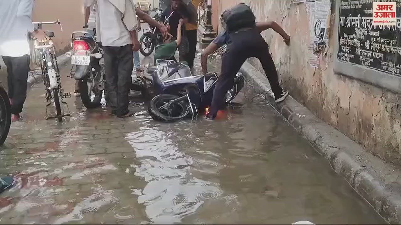 VIDEO : Disasterous rain in Varanasi bike entered into main hole people saved the woman