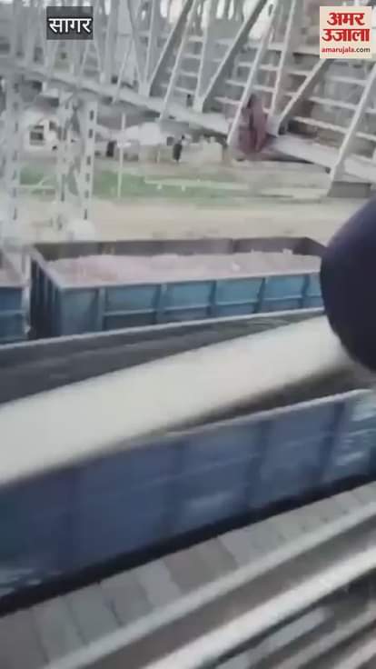 Woman sitting on railway foot over bridge jumped over moving goods train