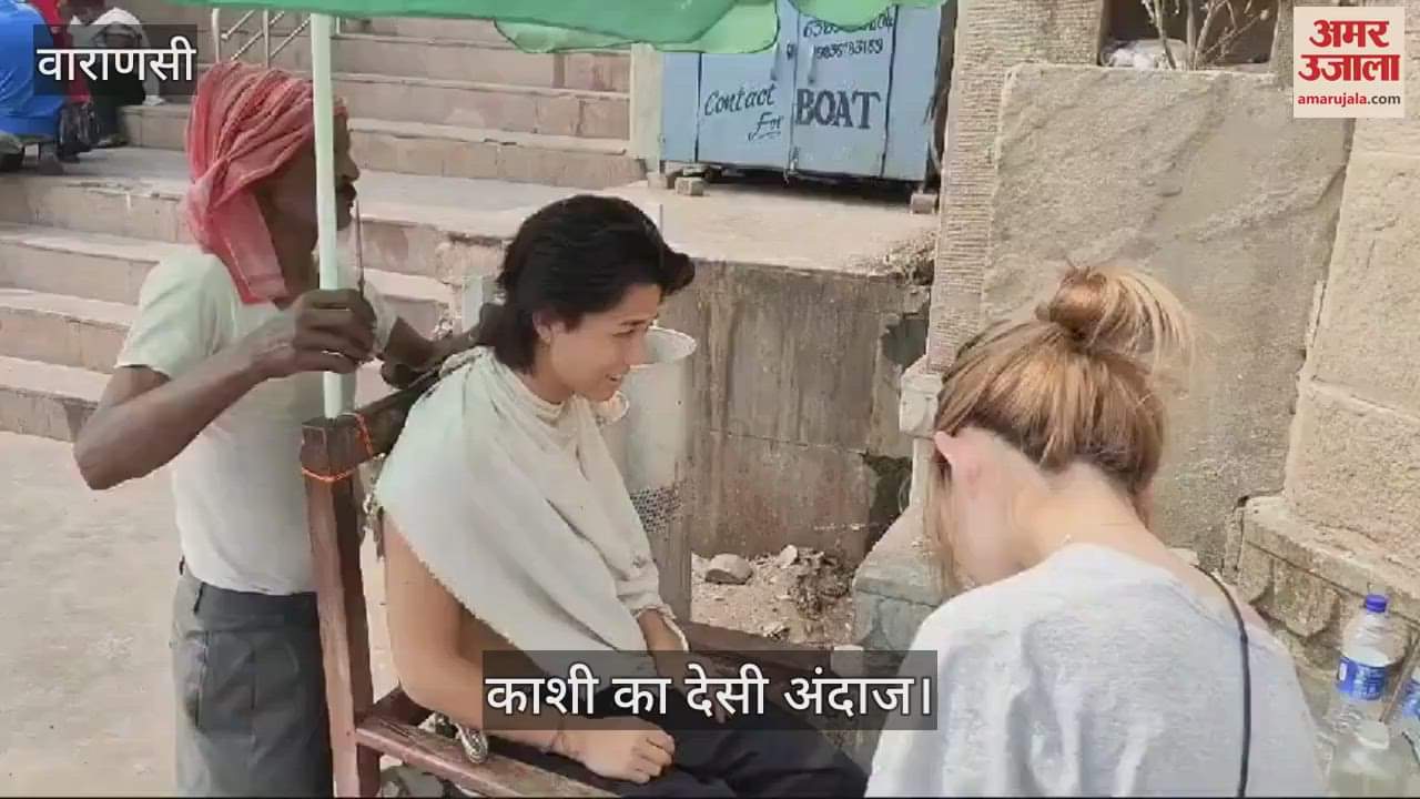 VIDEO : this is Banaras a foreigner is getting his hair done at a local salon he is seen attracting people crowd gathers