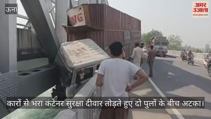 A container full of cars broke the safety wall and got stuck between two bridges