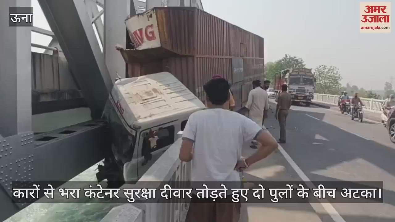 A container full of cars broke the safety wall and got stuck between two bridges