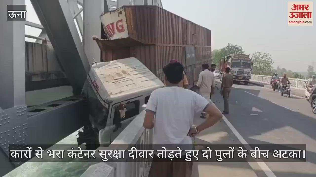 A container full of cars broke the safety wall and got stuck between two bridges