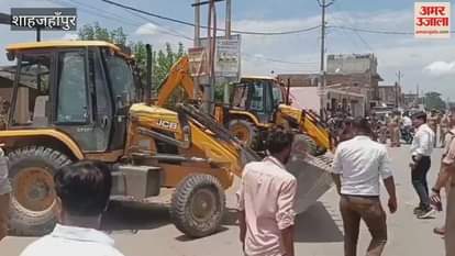 houses and shops built on pond land were demolished with a bulldozer in shahjahanpur