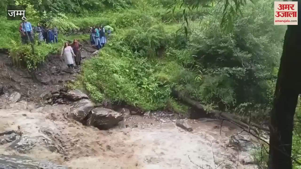 The consequence of not having a bridge: School children stranded in heavy rain, rescued by local people