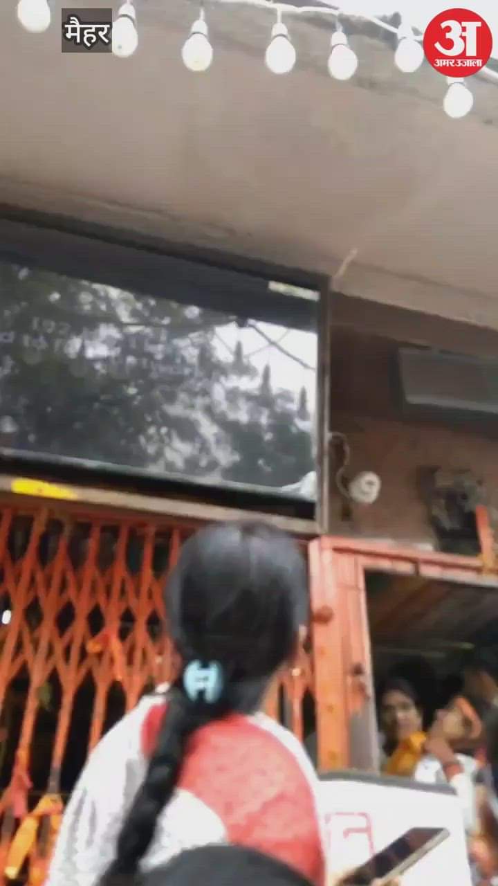 A snake wrapped around screen at Maihar Sharda Dham, causing panic among visitors