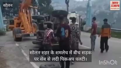 pickup loaded with apples overturned in the middle of the road in Shamlech