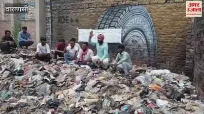 Protested by sitting on pile of garbage officials assured cleaning