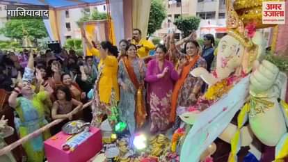 Female devotees danced with enthusiasm during the immersion of Bappa in a society