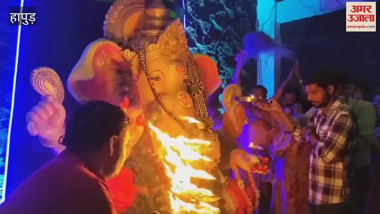 Devotees participating in the Maha Aarti held at night during the Ganeshotsav program