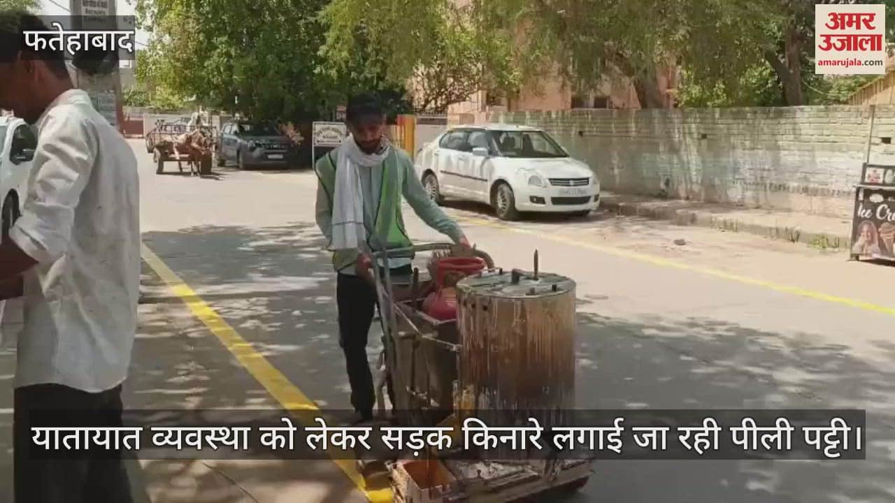 Yellow strip is being installed on the roadside for traffic management
