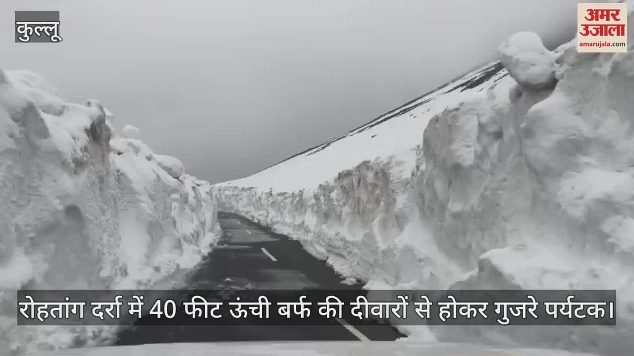 Tourists passed through 40 feet high snow walls at Rohtang Pass