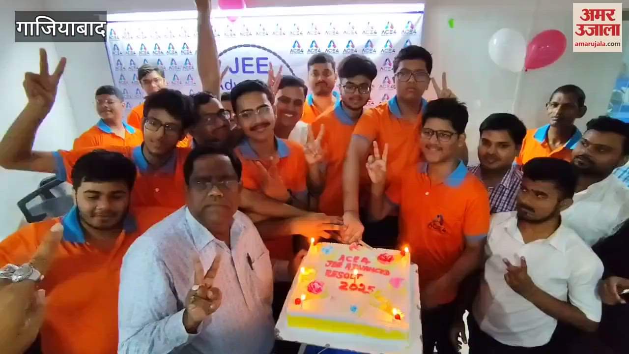 Students celebrating by cutting cake with teachers at RDC centre after passing JEE Mains exam