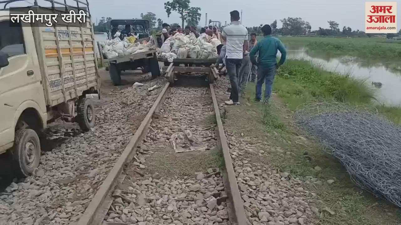 Railway workers and volunteers are busy stopping the leakage of water from under the railway line in Lakhimpur Kheri
