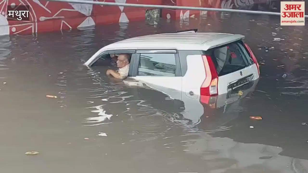 Car drowns in waterlogged road family trapped in water