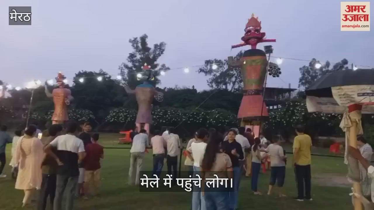 Ravana's effigy stands erect in the rain, as his pride and arrogance draw people to the fair.