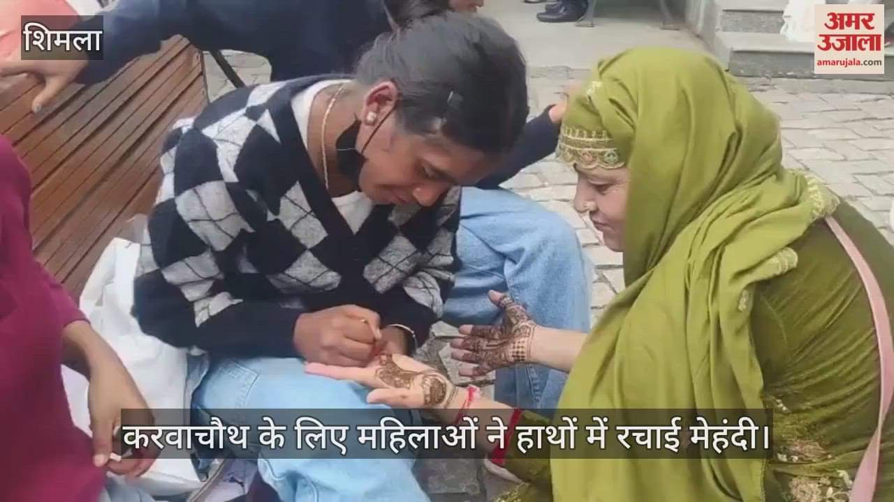 Women apply mehndi on their hands for Karva Chauth