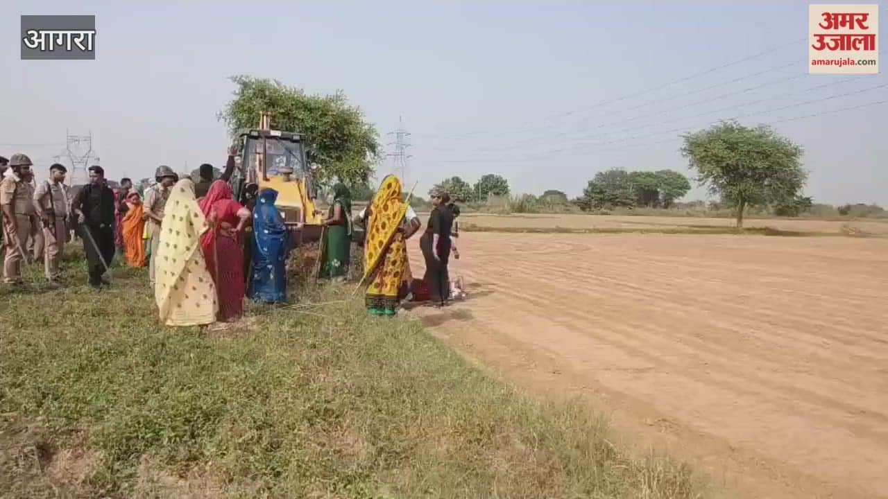 Women lay down in front of bulldozer