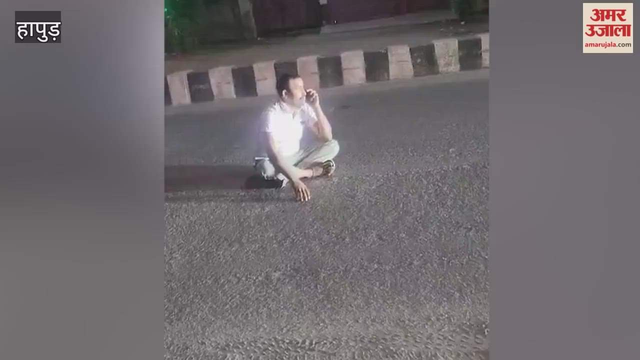 Drunk policeman creates ruckus while sitting in middle of road in Hapur