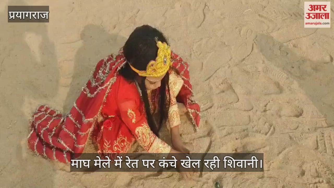 Shivani plays marbles on the sand at the Magh Mela, dressed as a goddess as she roams the fair.