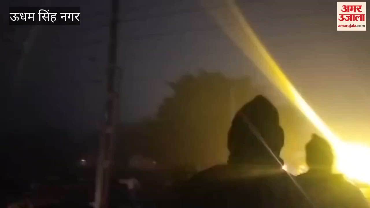 Bike riders passing under the railway gate despite it being closed amidst dense fog