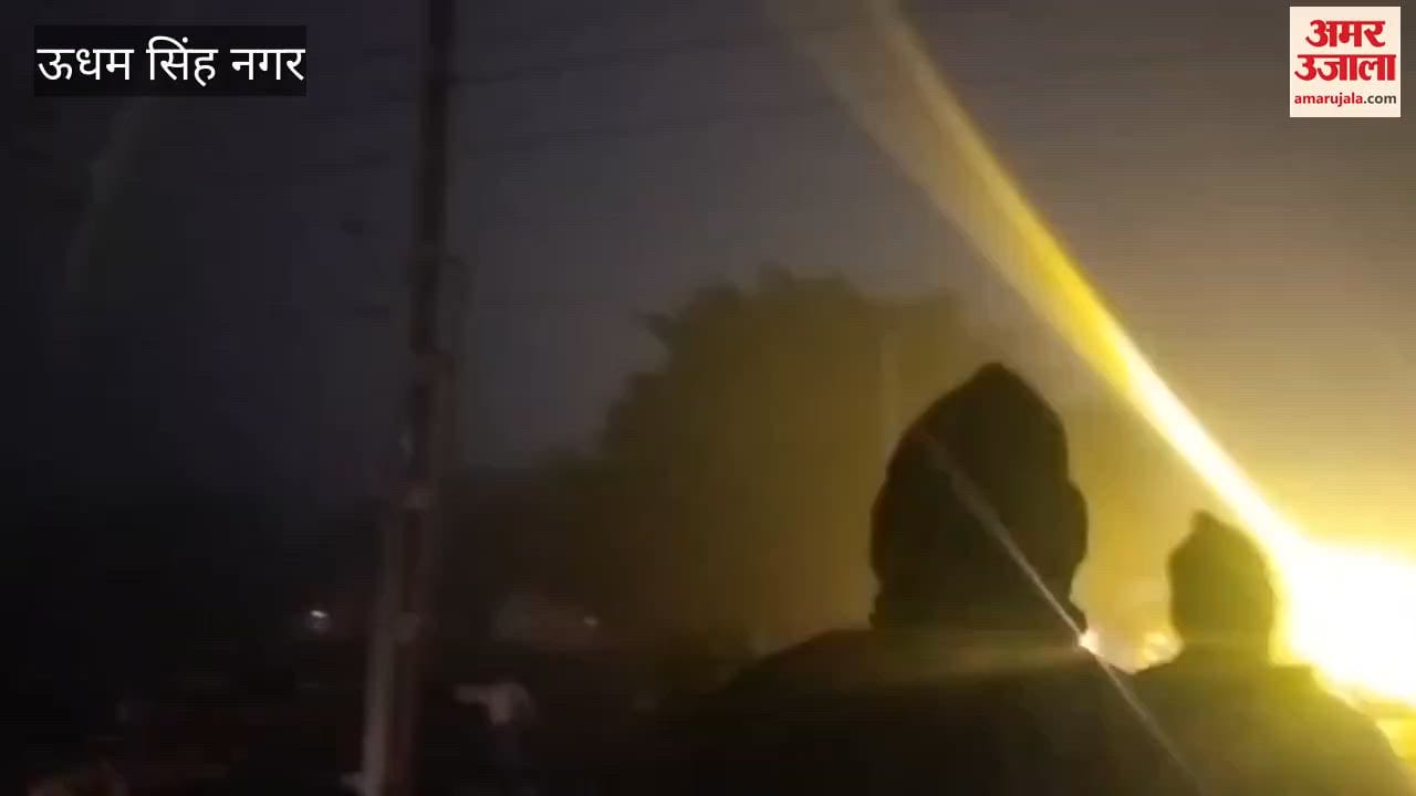 Bike riders passing under the railway gate despite it being closed amidst dense fog