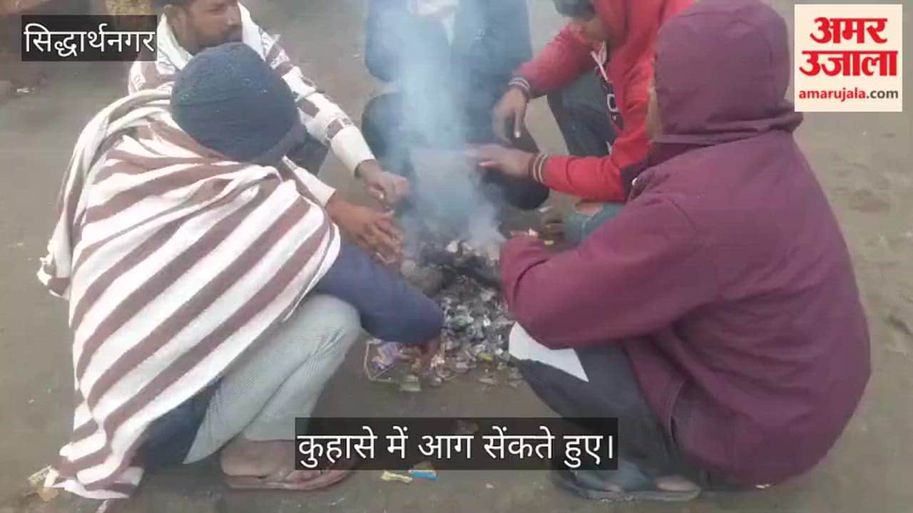 Fog increases cold, pedestrians burn garbage to try and beat the chill