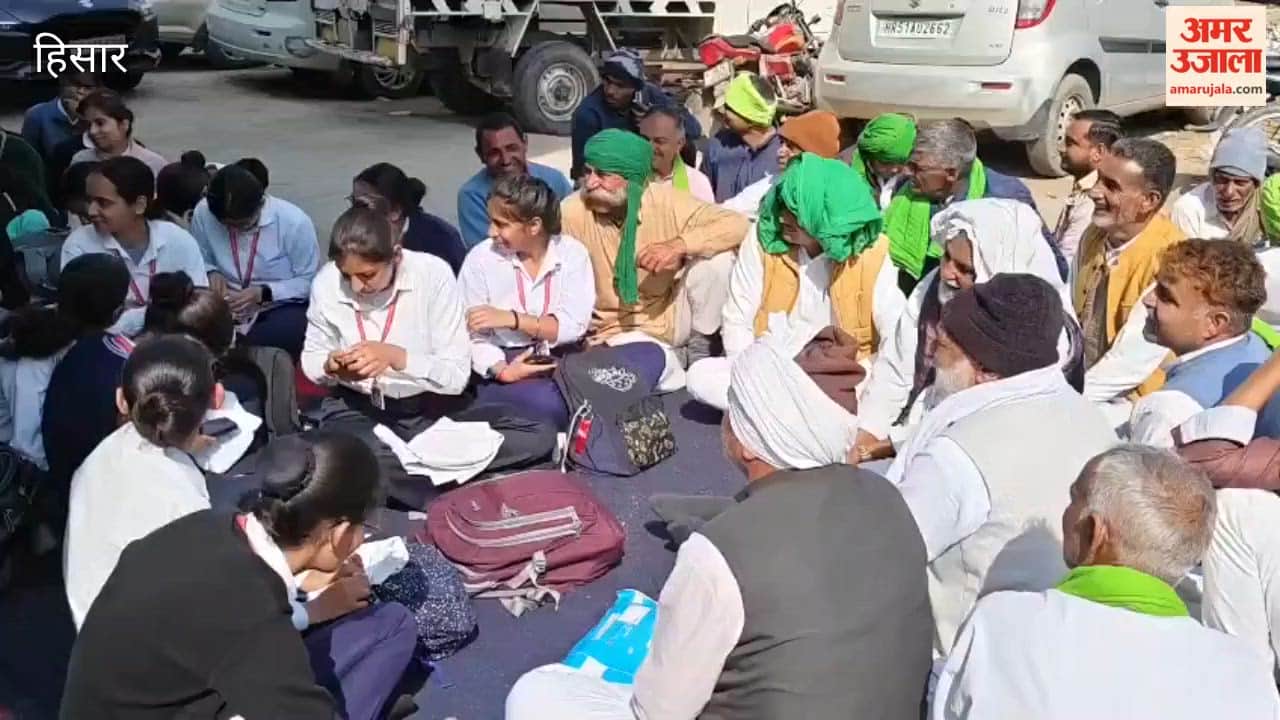 Students sit outside MLA's residence in Hansi, protesting against not getting migration certificate