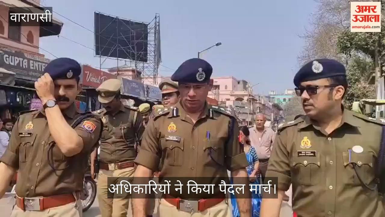 Police officers staged a foot march in Varanasi