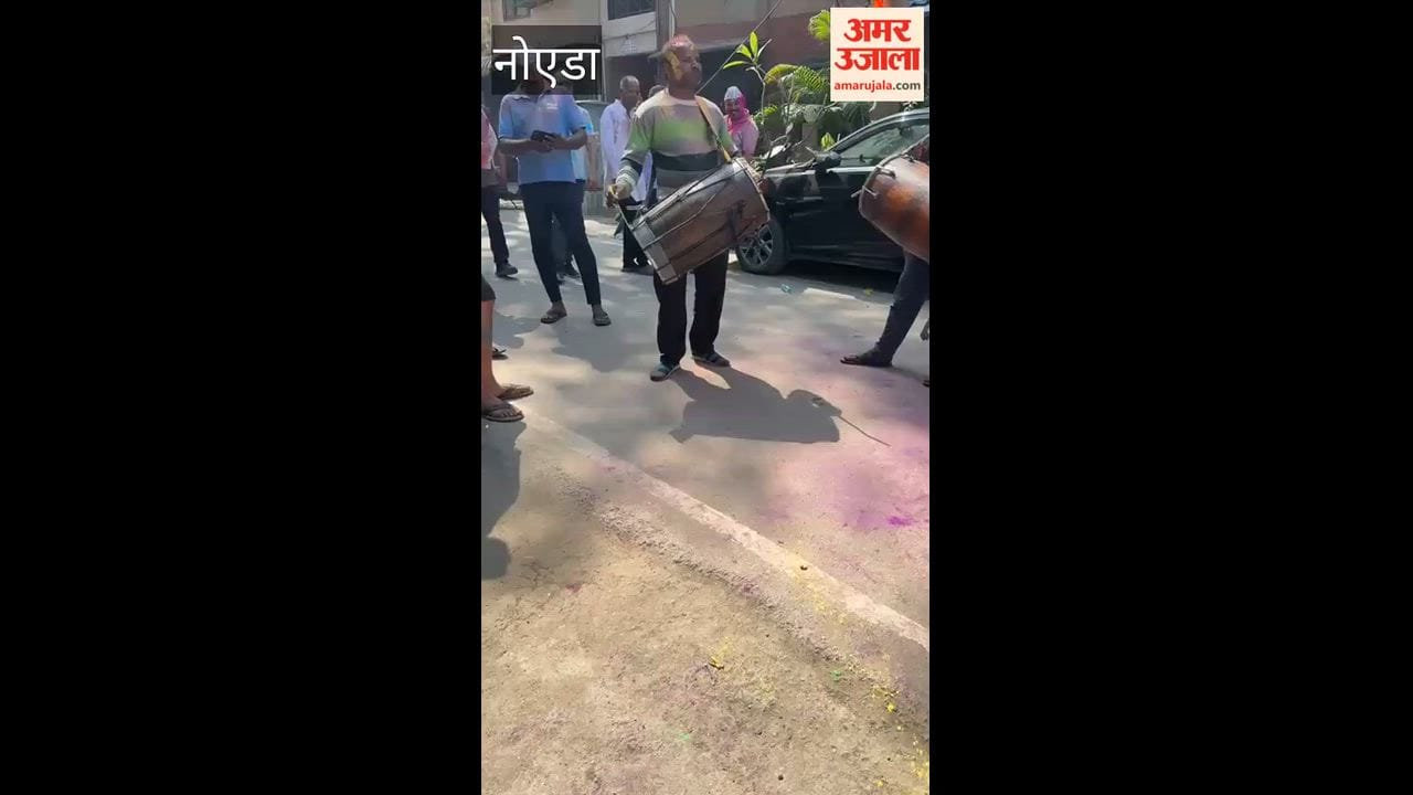 People playing Holi in Sector 62, Noida.