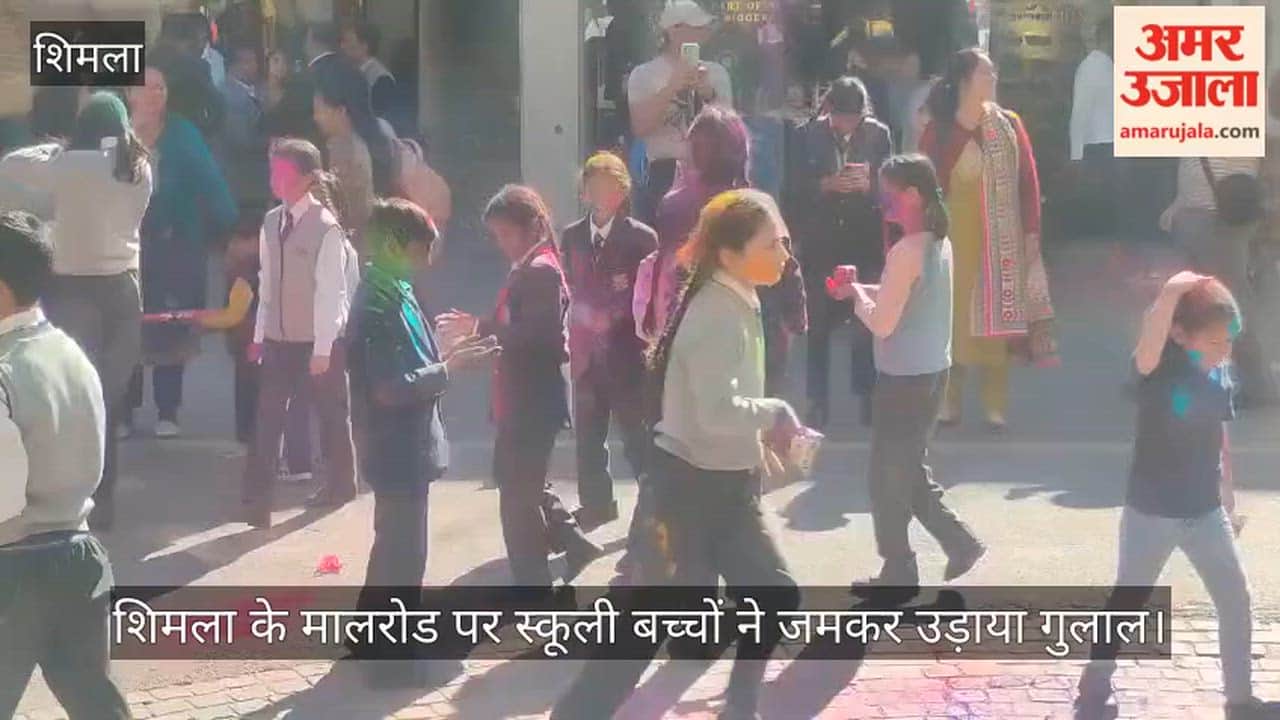 School children threw gulal on Shimla's Mall Road.