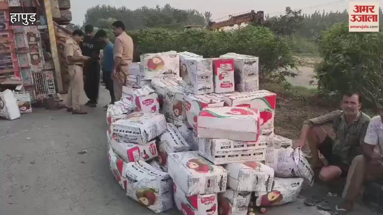 A truck loaded with apples overturned on the highway after steering was locked in Hapur