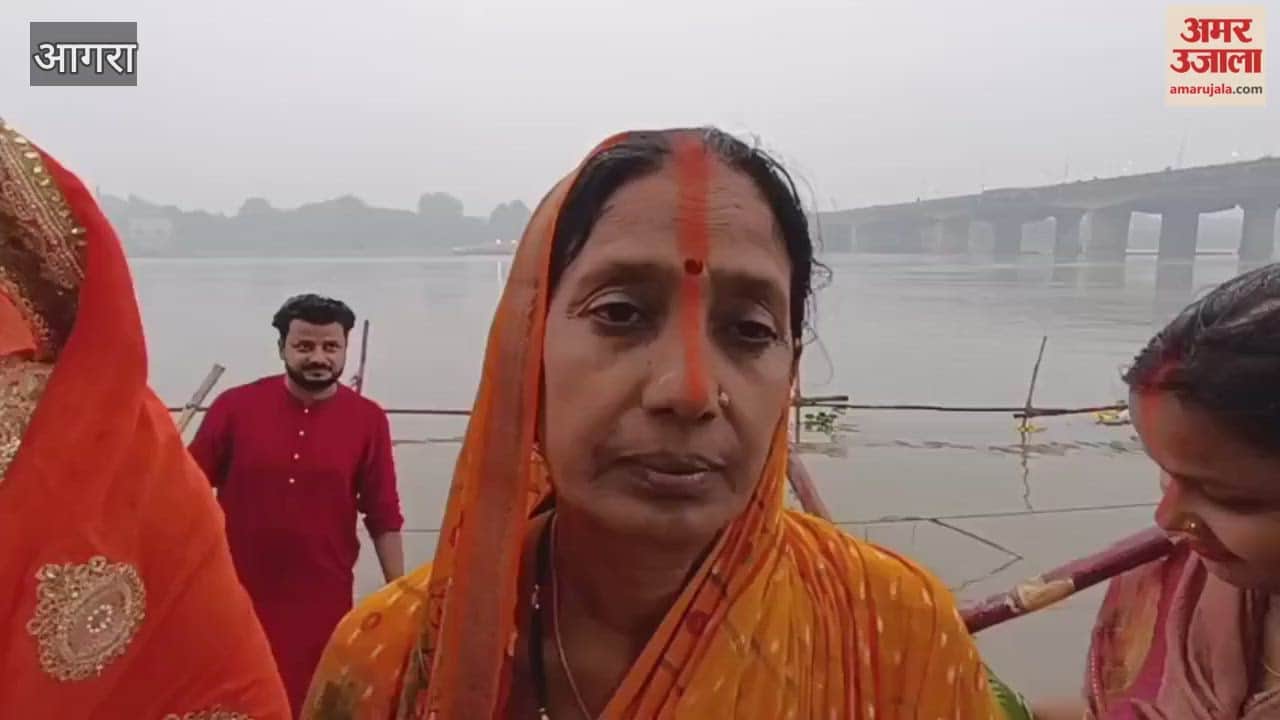 Women in Agra offer prayers to the rising sun during Chhath Puja at Yamuna Ghat