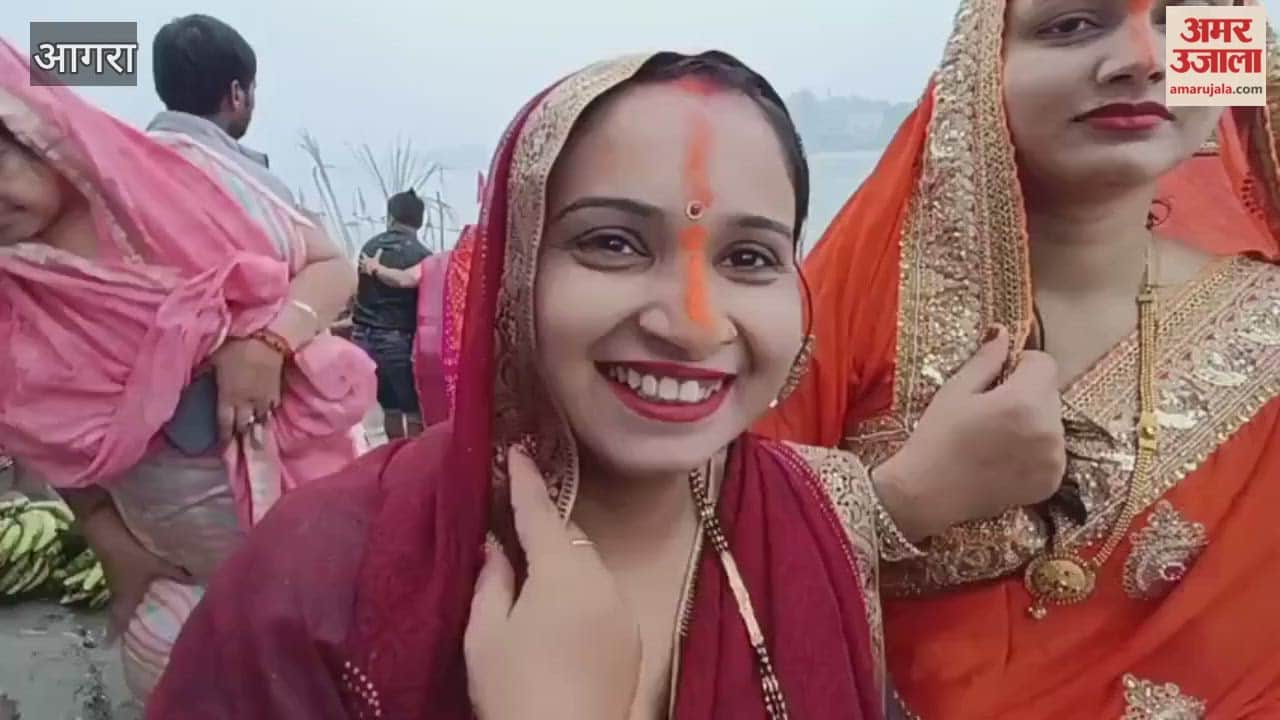 offer prayers to the rising sun during Chhath Puja at Yamuna Ghat