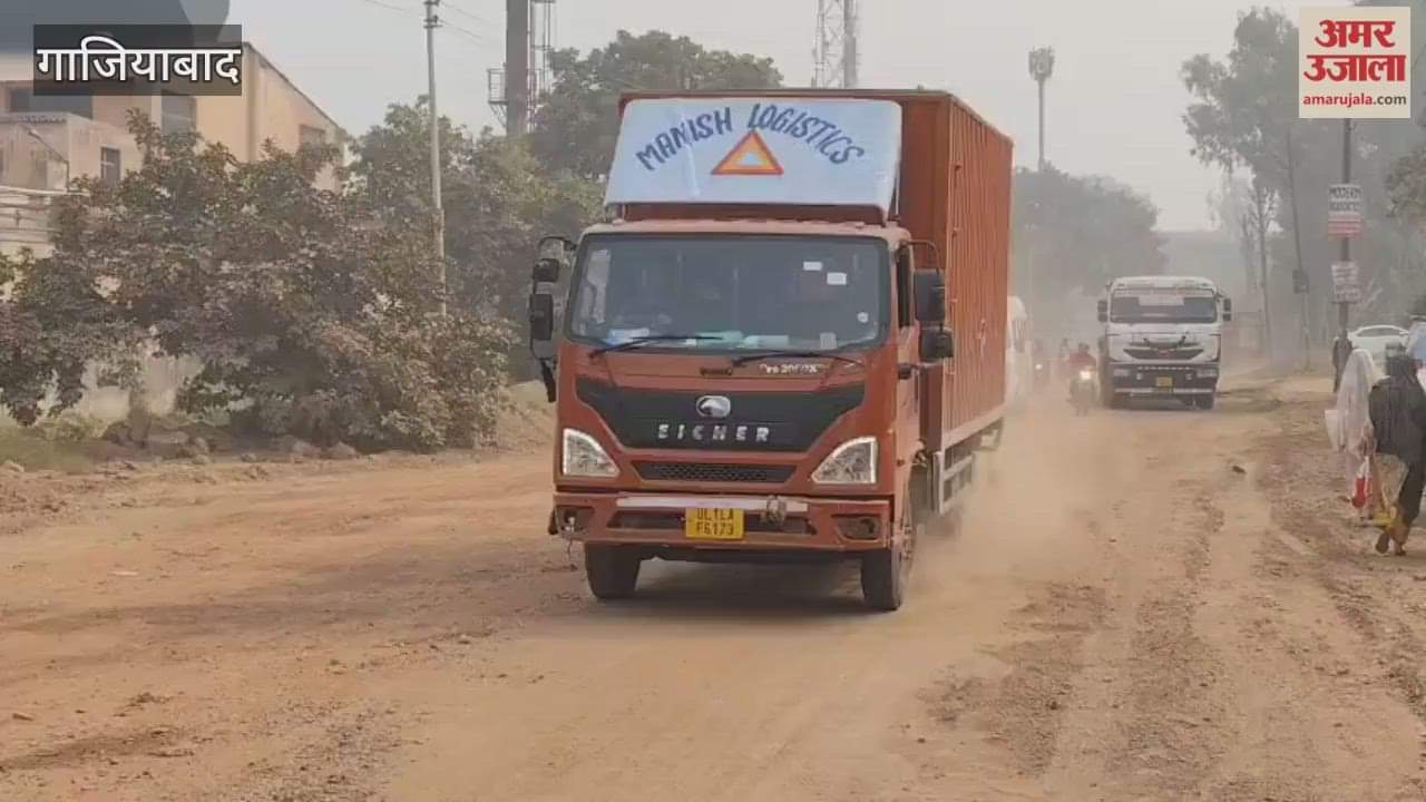 Dust flying due to vehicles passing through broken road in Sahibabad