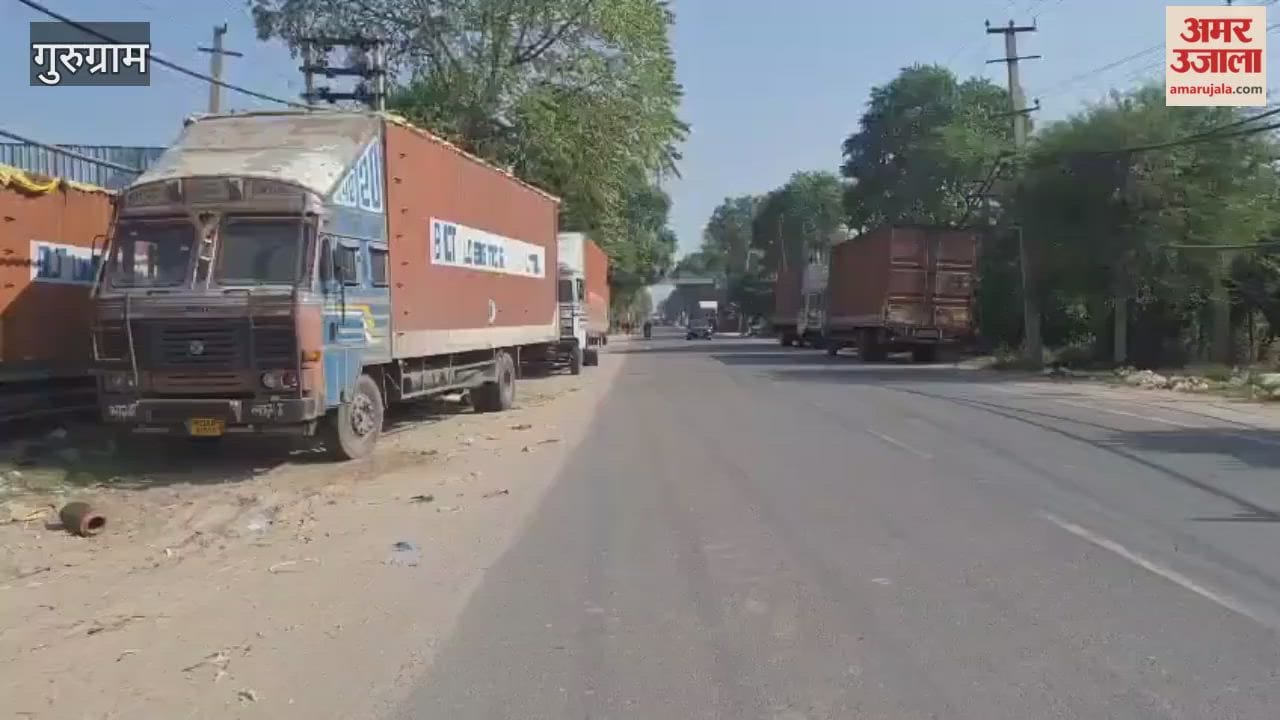 large vehicles are parked on both sides of road In Pataudi