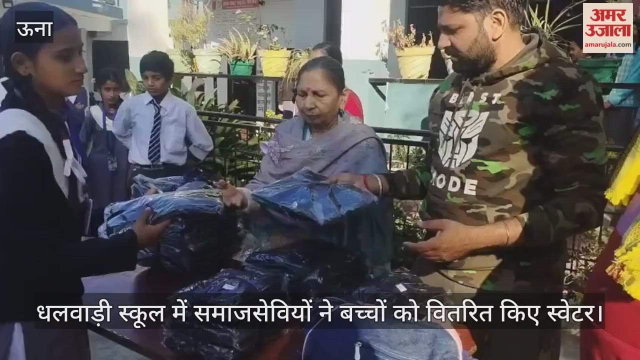 Social workers distributed sweaters to children at Dhalwadi School.