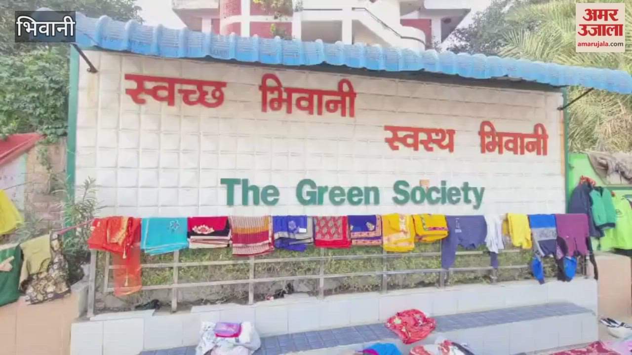 used clothes market is set up in front of wall that promotes cleanliness in Bhiwani