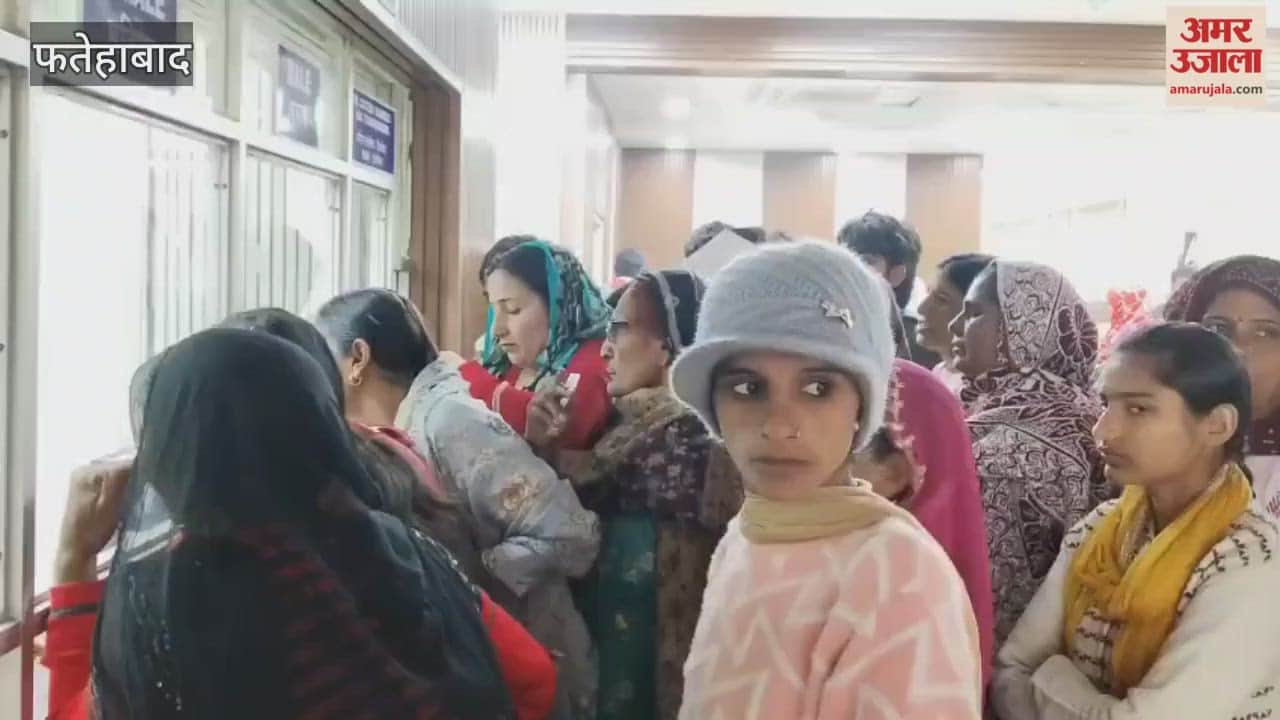 In Fatehabad, two employees are on duty at the OPD registration counter, and patients are lining up for registration slips.