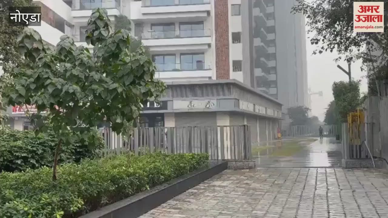 Water is being sprayed in society to reduce AQI noida