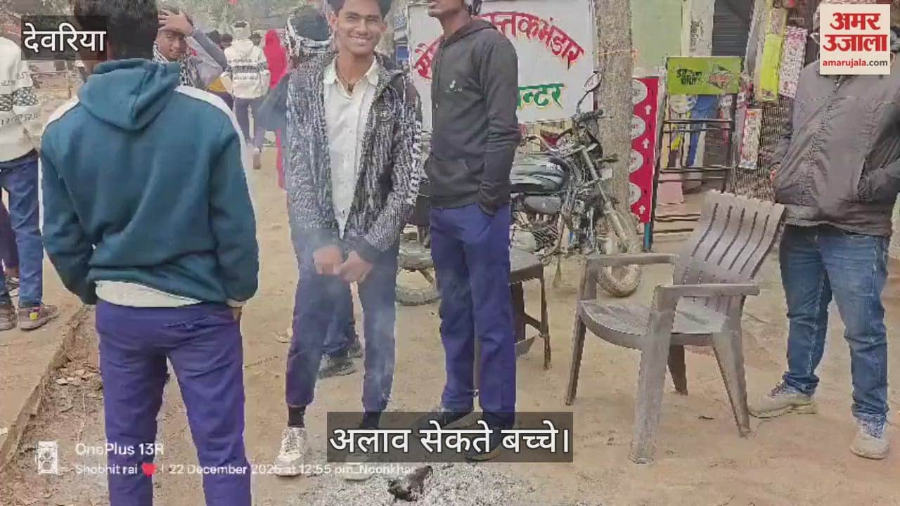 Students shivering in the cold are warming themselves by bonfires