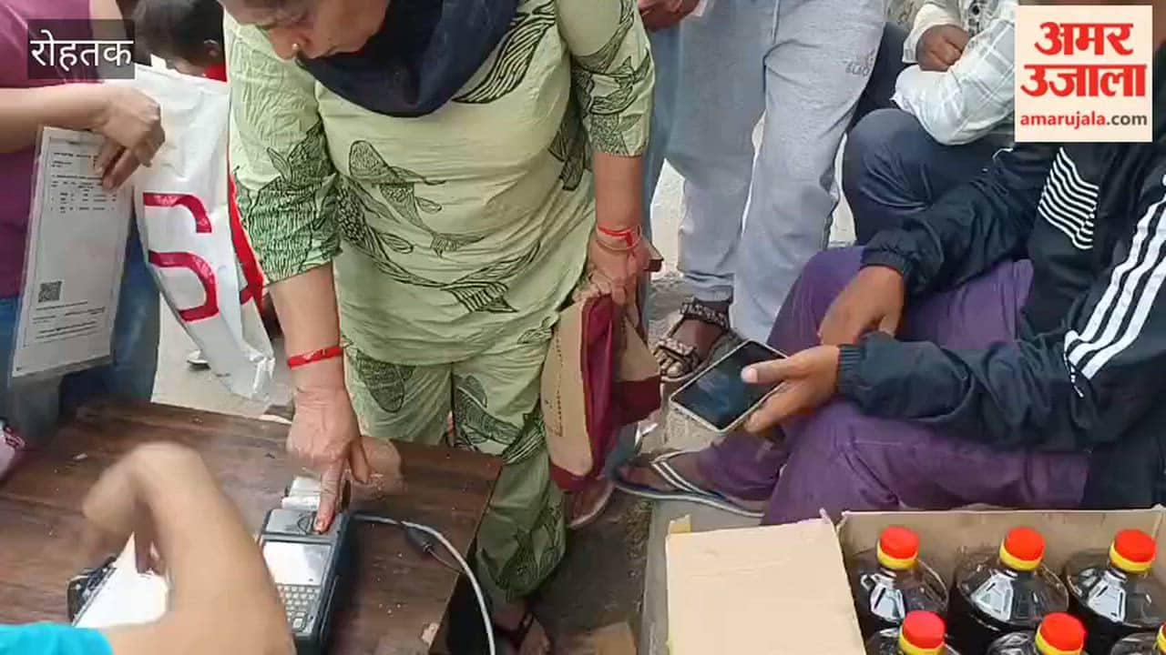 Consumers queue up at the ration depot in Rohtak.