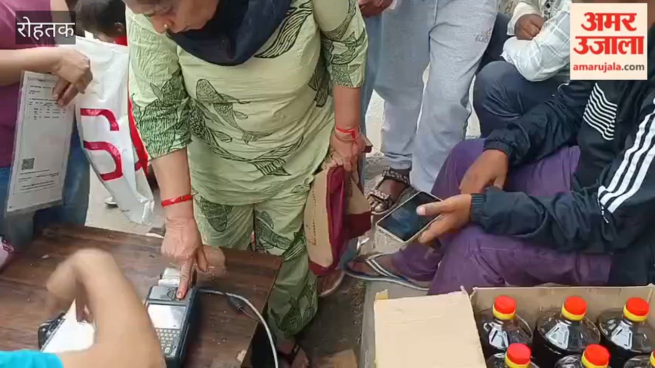 Consumers queue up at the ration depot in Rohtak.