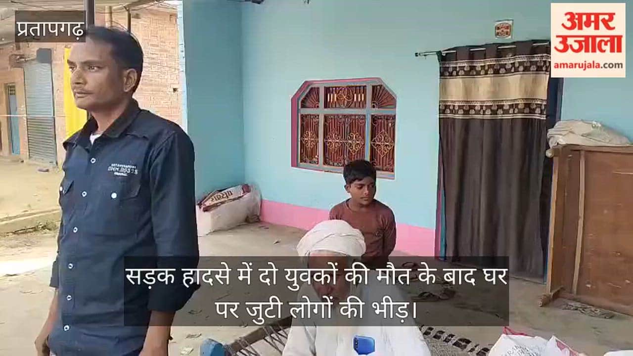 Crowds gathered at the home of two youths who died in a road accident.