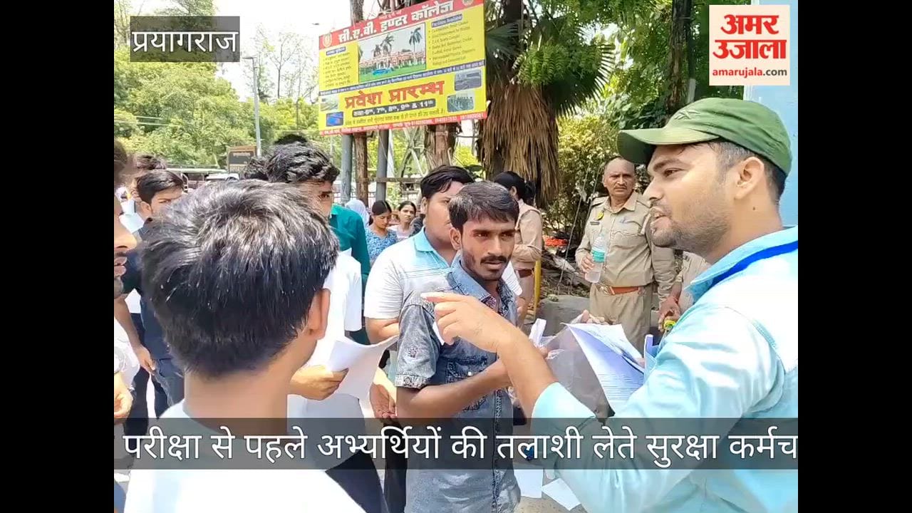 Security personnel frisking candidates at a school gate in Prayagraj ahead of the NEET exam.