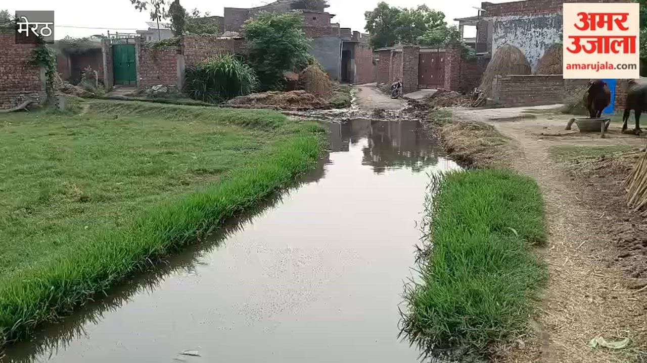 Water accumulates on village road due to lack of drainage; villagers distressed.