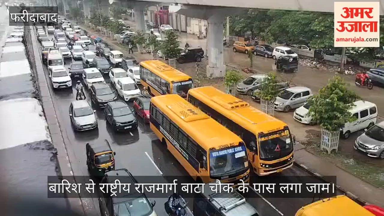 Rain in Faridabad causes a traffic jam on the National Highway near Bata Chowk.