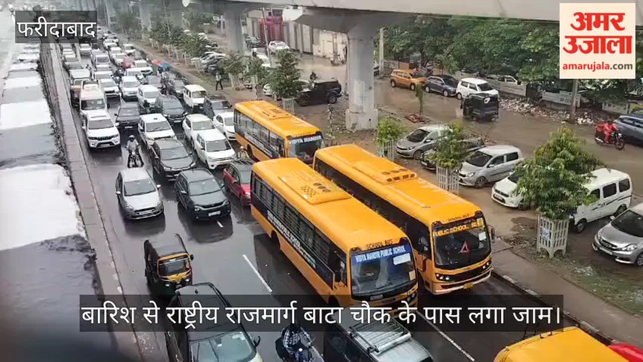 Rain in Faridabad causes a traffic jam on the National Highway near Bata Chowk.