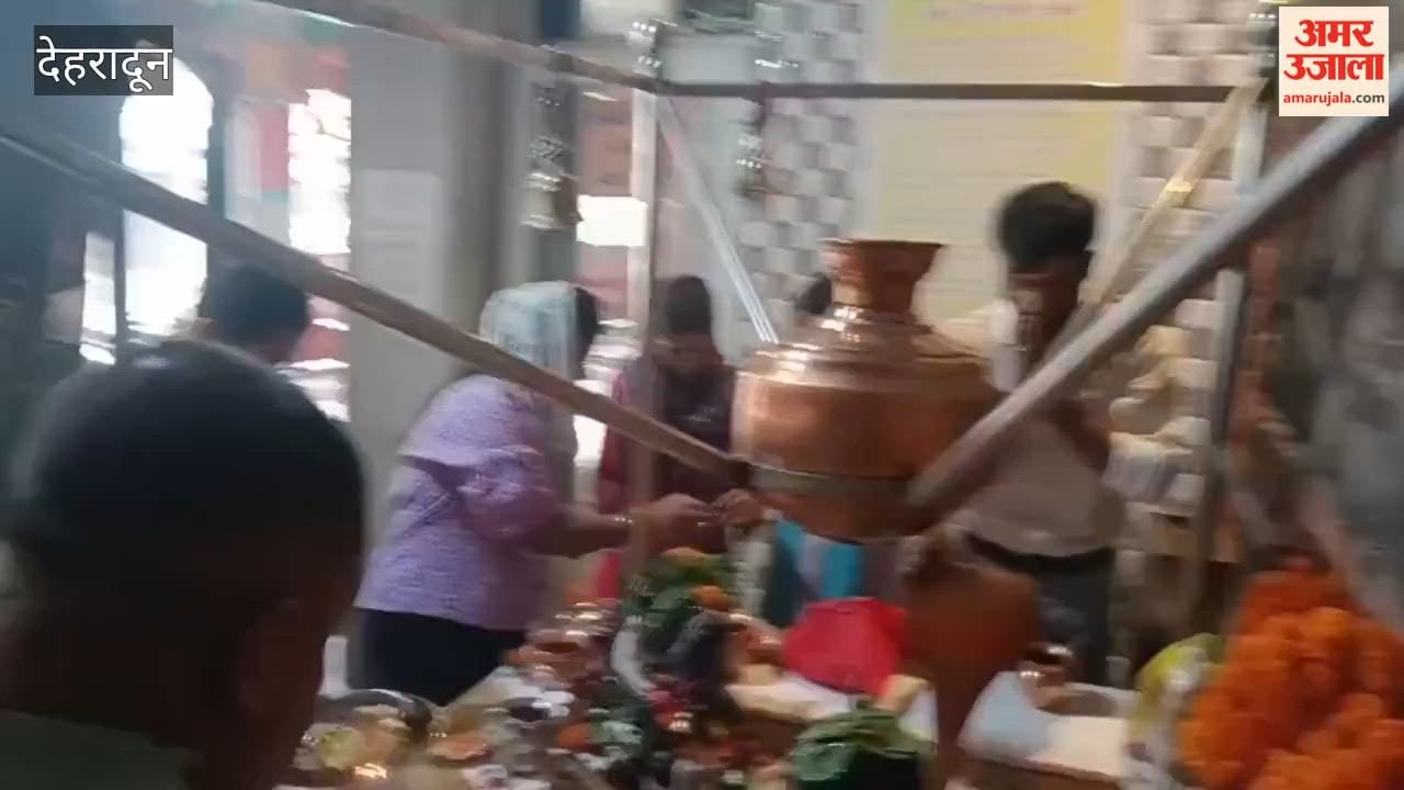 Dehradun:A Shiva devotee performing *Jalabhishek* (ritual offering of water) on the *Shivling* at the Lakshmi Narayan Panchayati Temple in Araghar